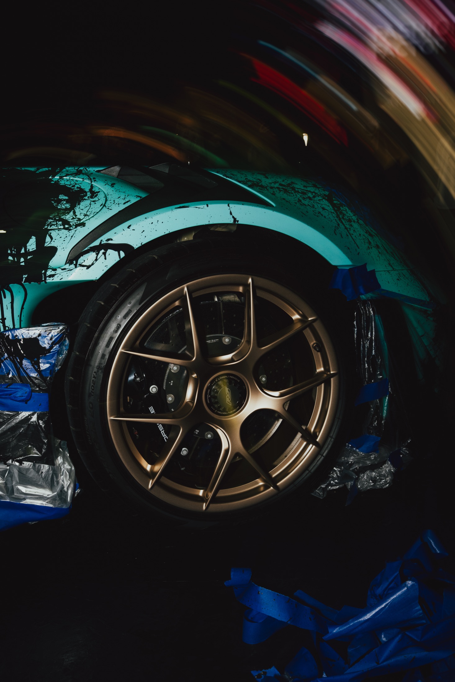 Signature splatter over the forged bronze wheels.